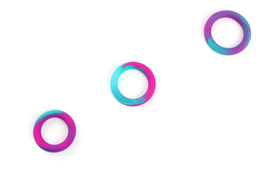 Three multicolored (blue, hot pink, and purple) silicone cock rings in small, medium, and large sizes on a white background