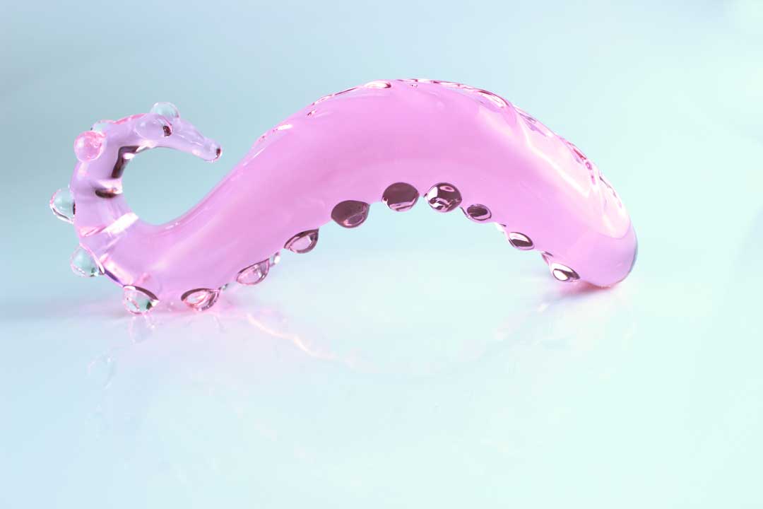 Bumpy pink Girthy Glass Tentacle Dildo upside down on white background