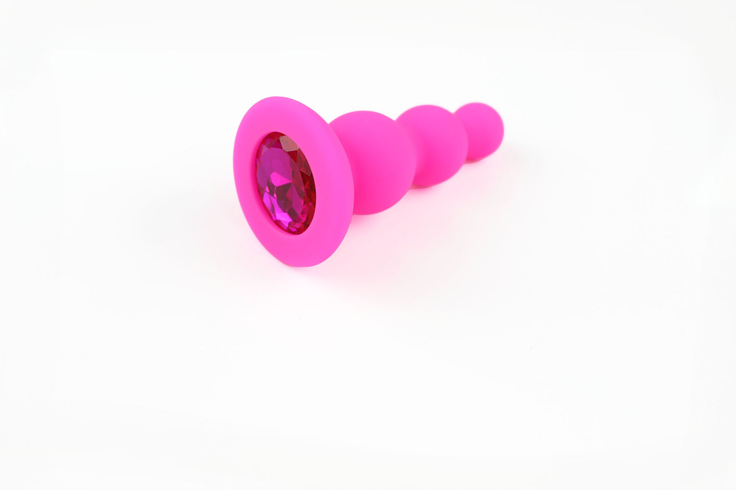 Hot pink beaded gem butt plug on a white background