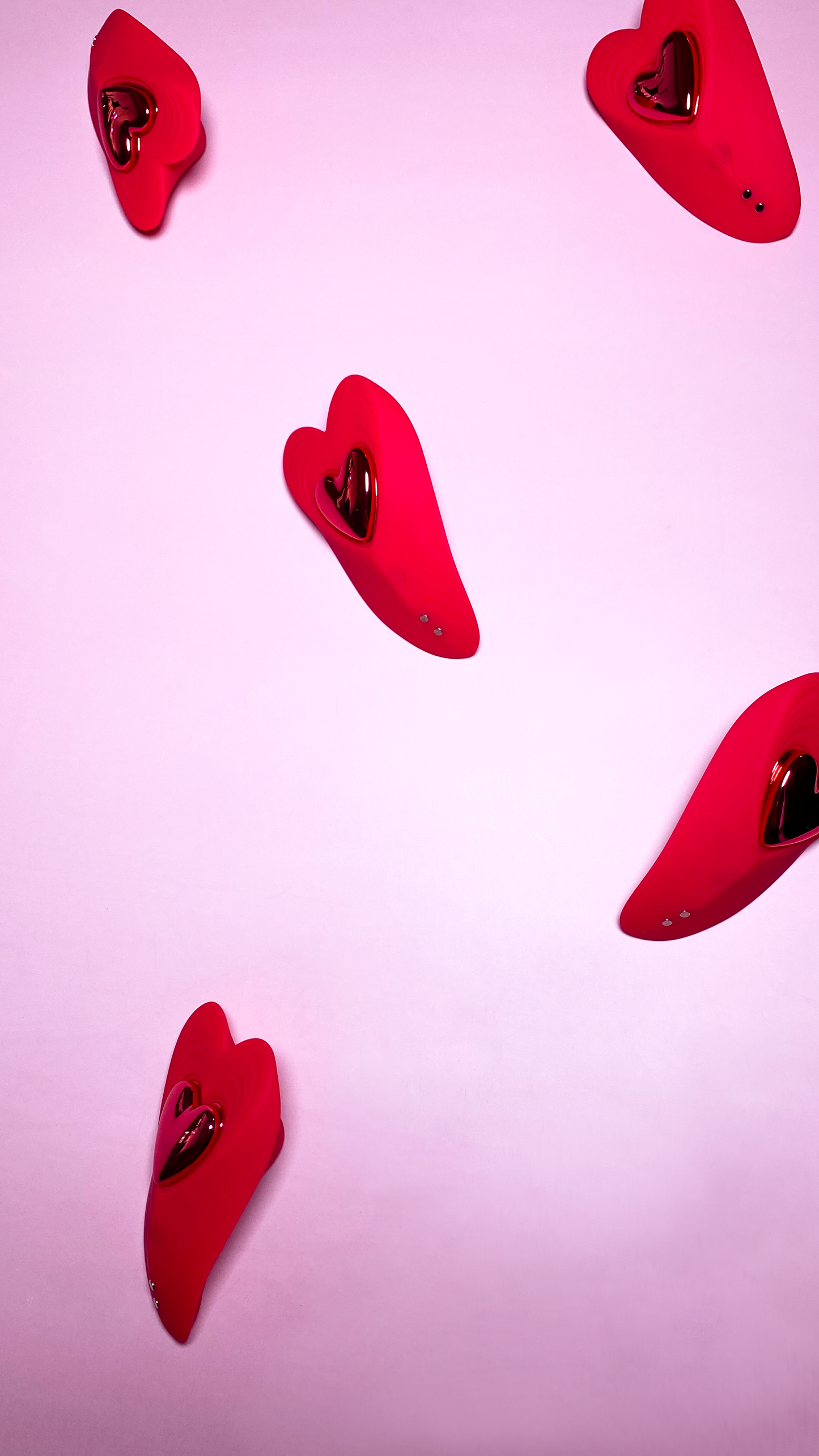 Multiple Red Lovie Panty Vibrators on a pink background