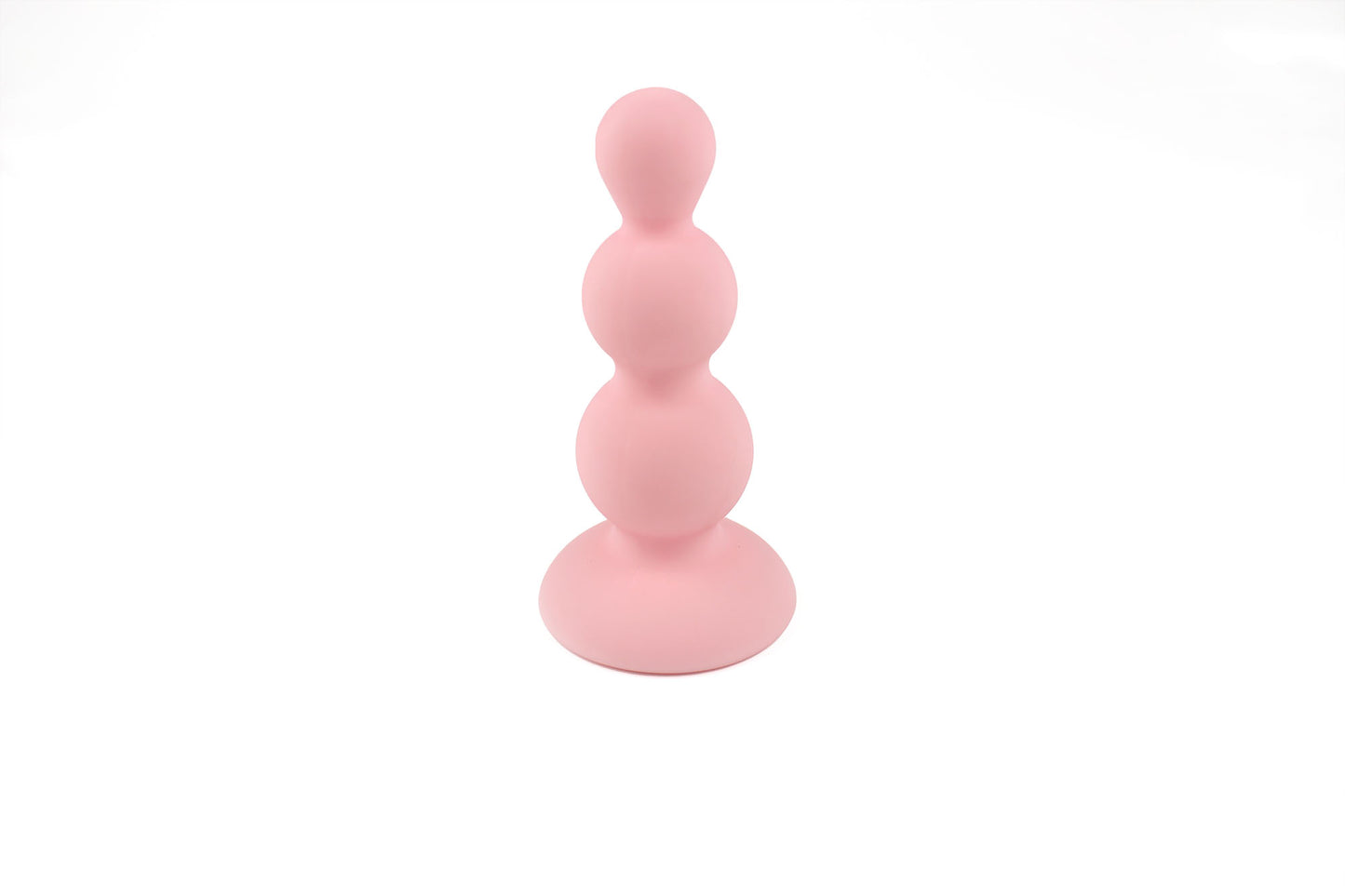 Peach pink beaded gem butt plug stood upright on its base on a white background