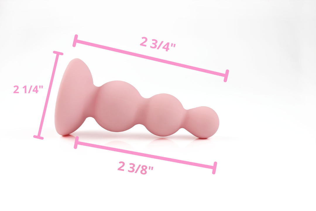 Side view of peach pink beaded gem butt plug and its measurements on a white background