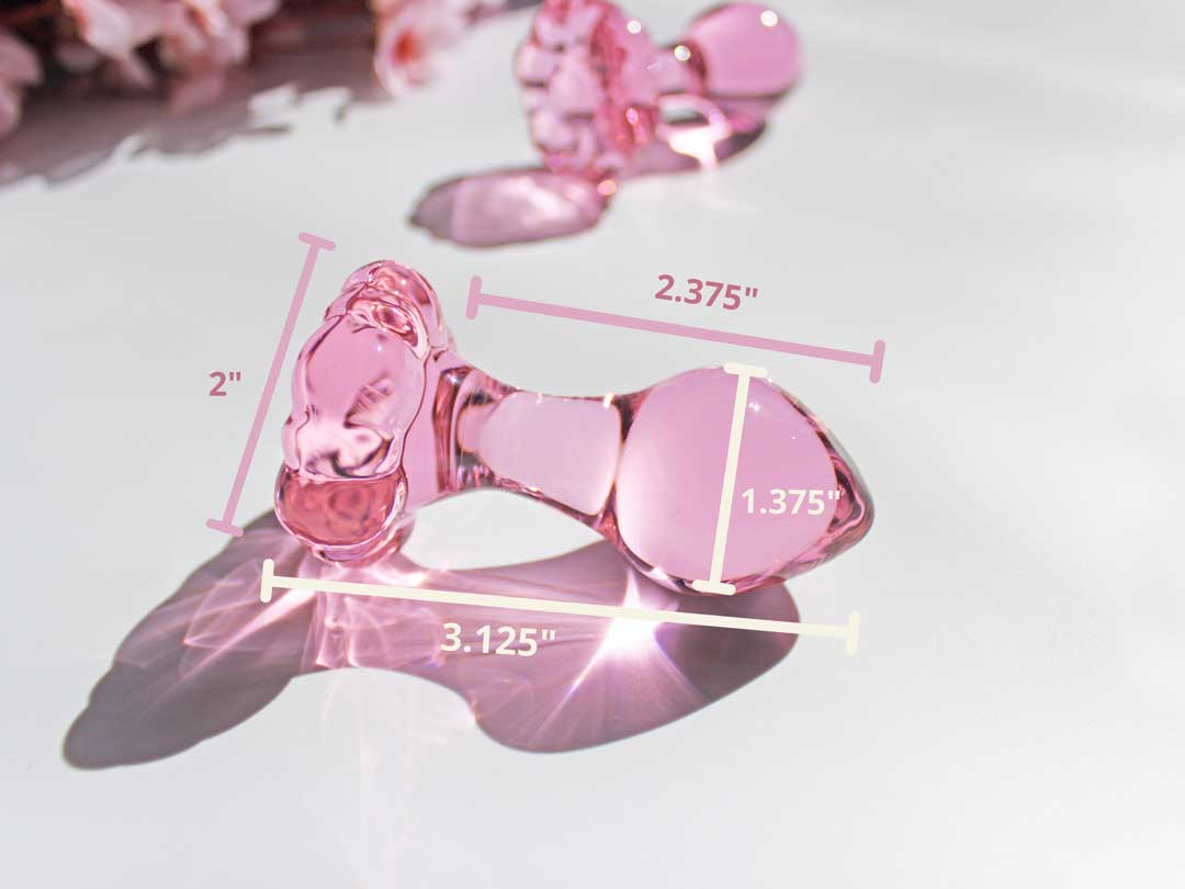 pink daisy glass butt plug with measurements of 2'' at che base 3.125'' inches total 2.375'' inches insertable and widest insertable area of 1.375''.