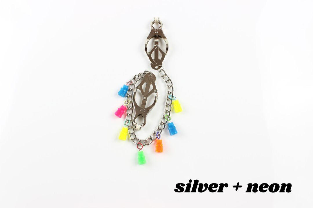 Silver clover clamps with chain and multicolored neon gummy bear charms above text reading silver + neon