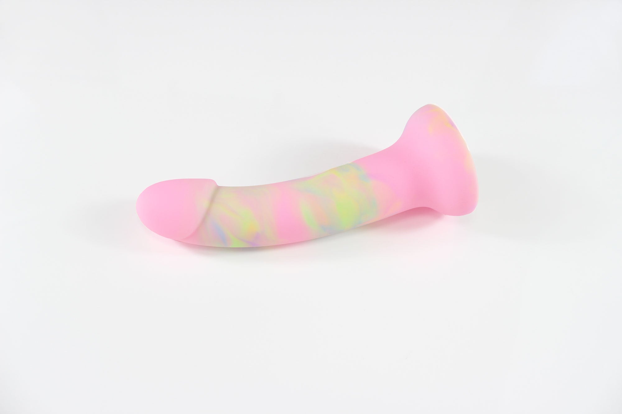 Pink, green, and blue marbled silicone dildo laying on white background