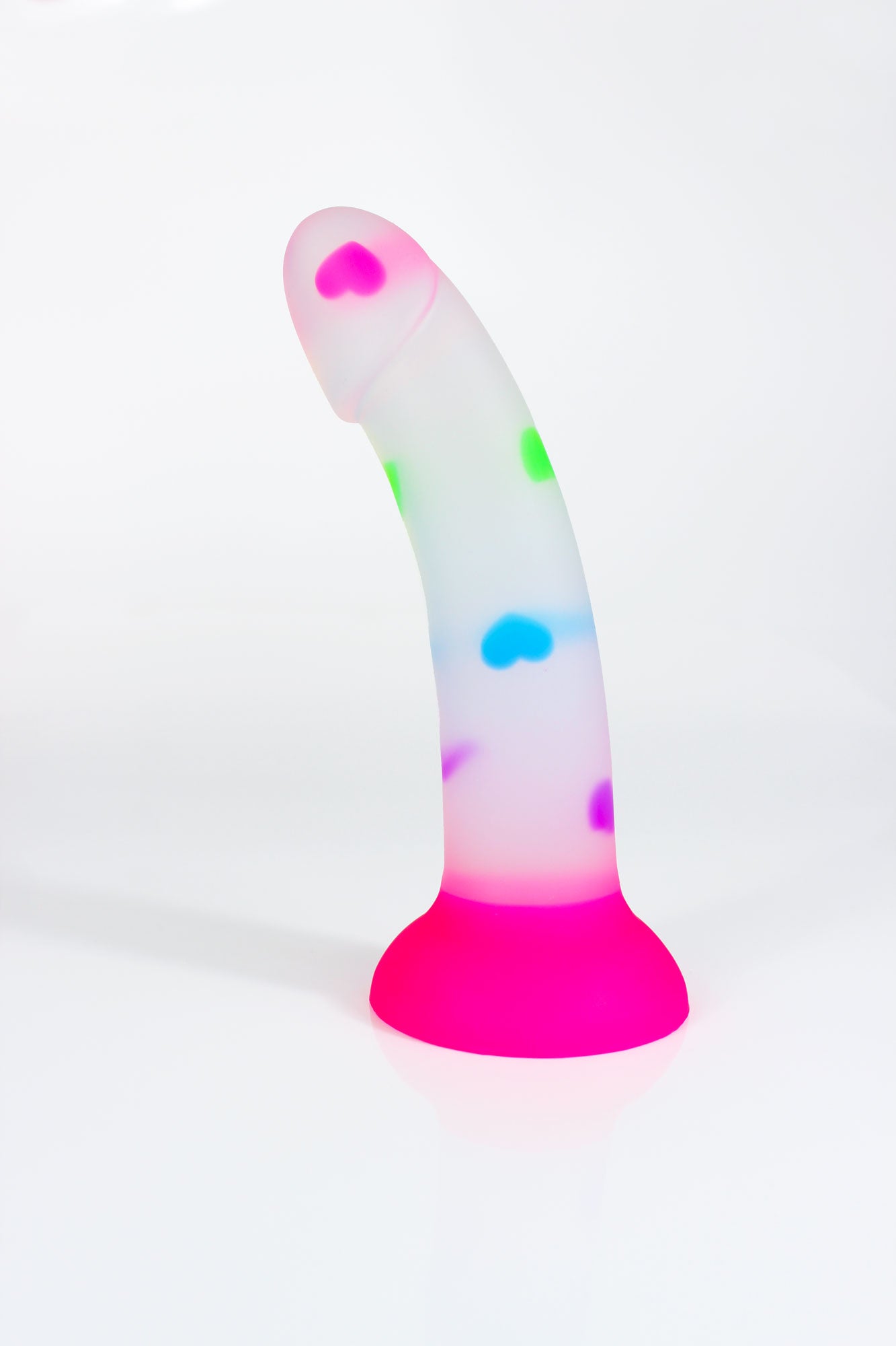 Opaque dildo with multicolored hearts and hot pink base on a white background