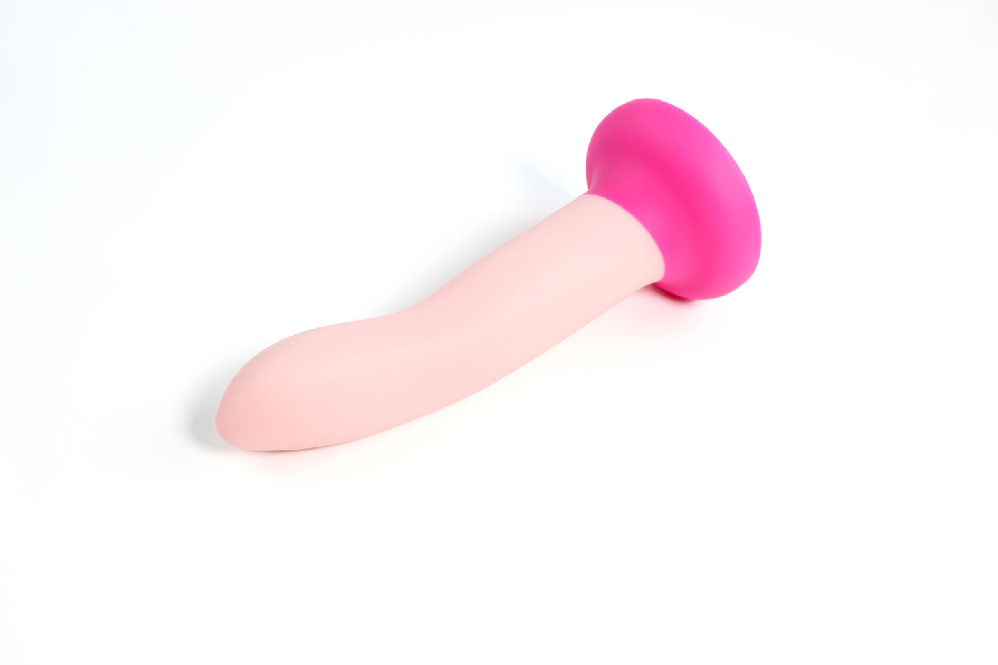 Colorblocked light pink and fuchsia dildo laying on a white background.