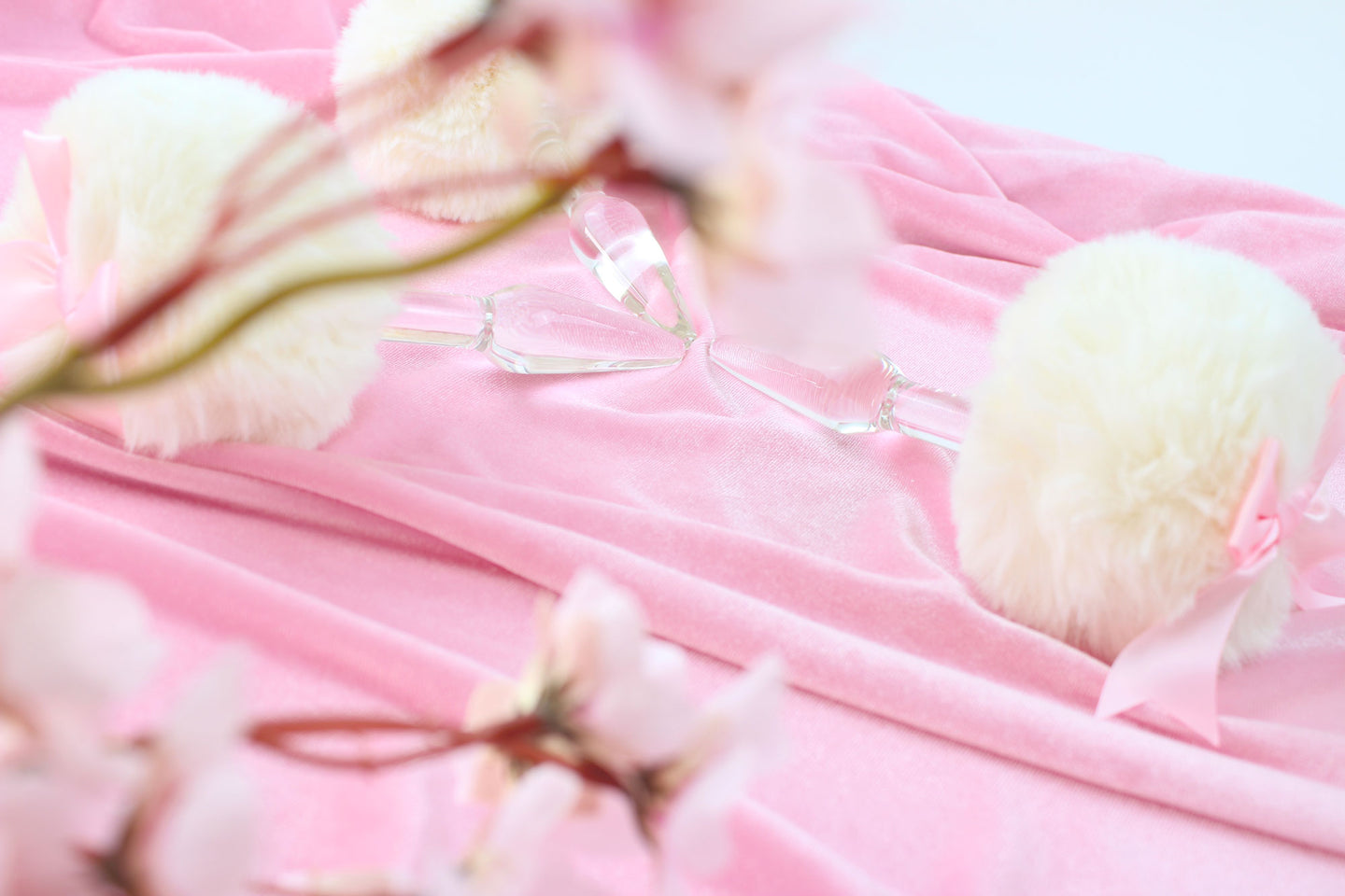 Side view of tapered glass tail plugs through out of focus cherry blossoms