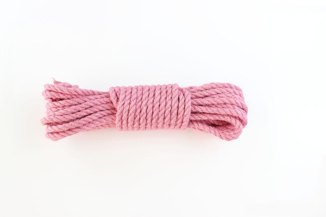 Pink jute rope on a white background.