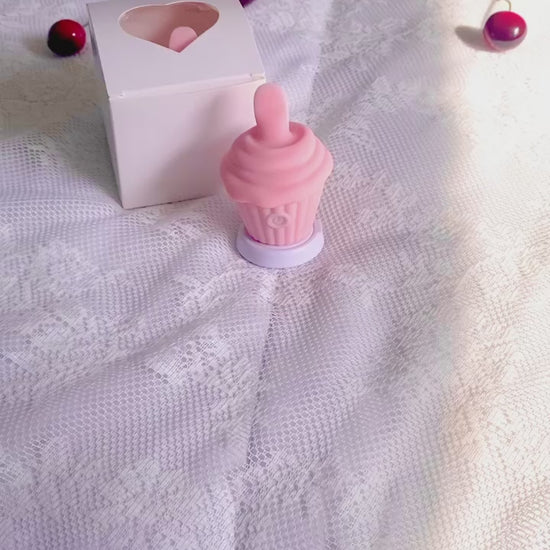 Hand picking up licking cupcake vibrator and cycling through the various settings