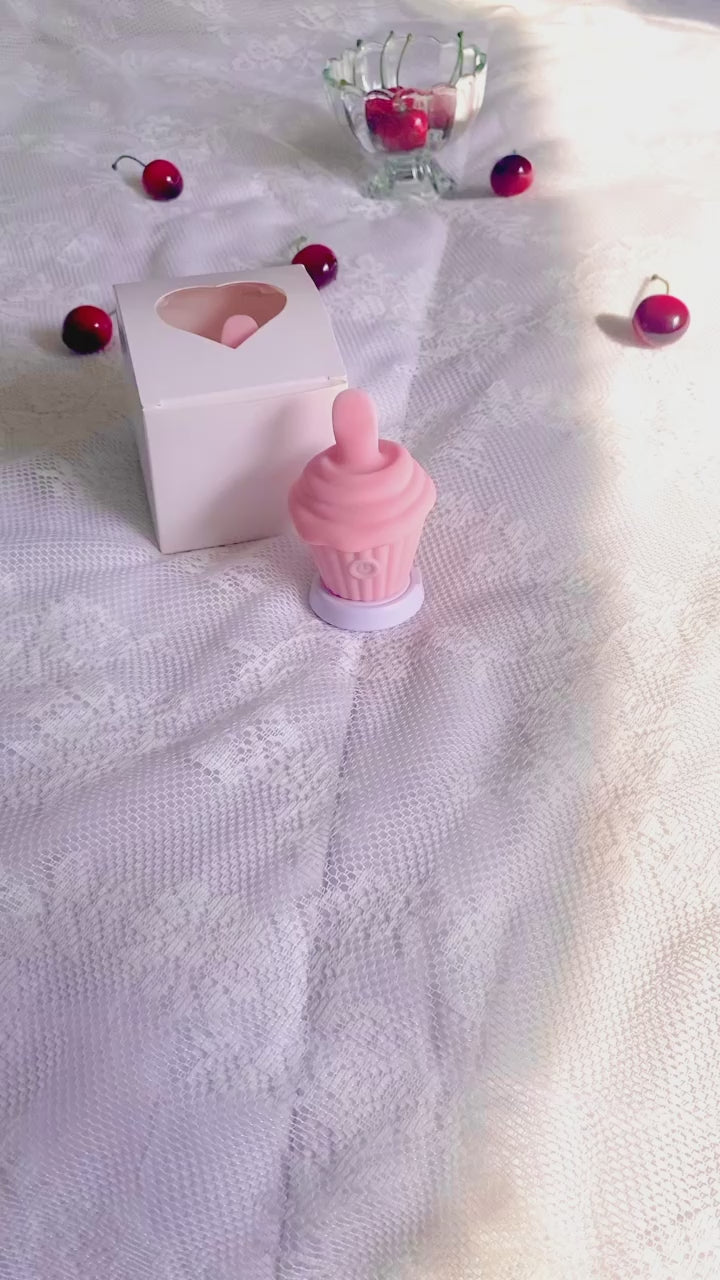 Hand picking up licking cupcake vibrator and cycling through the various settings