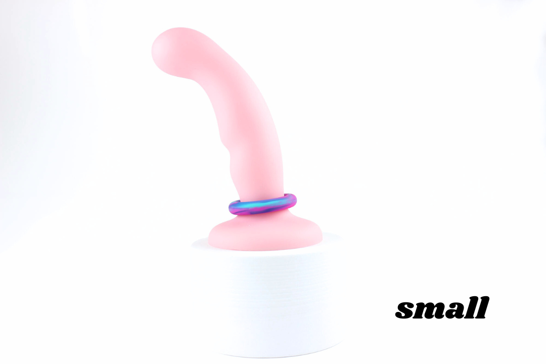 Small multicolored silicone cock ring on a pink dildo in front of a white background with corner text reading "small"
