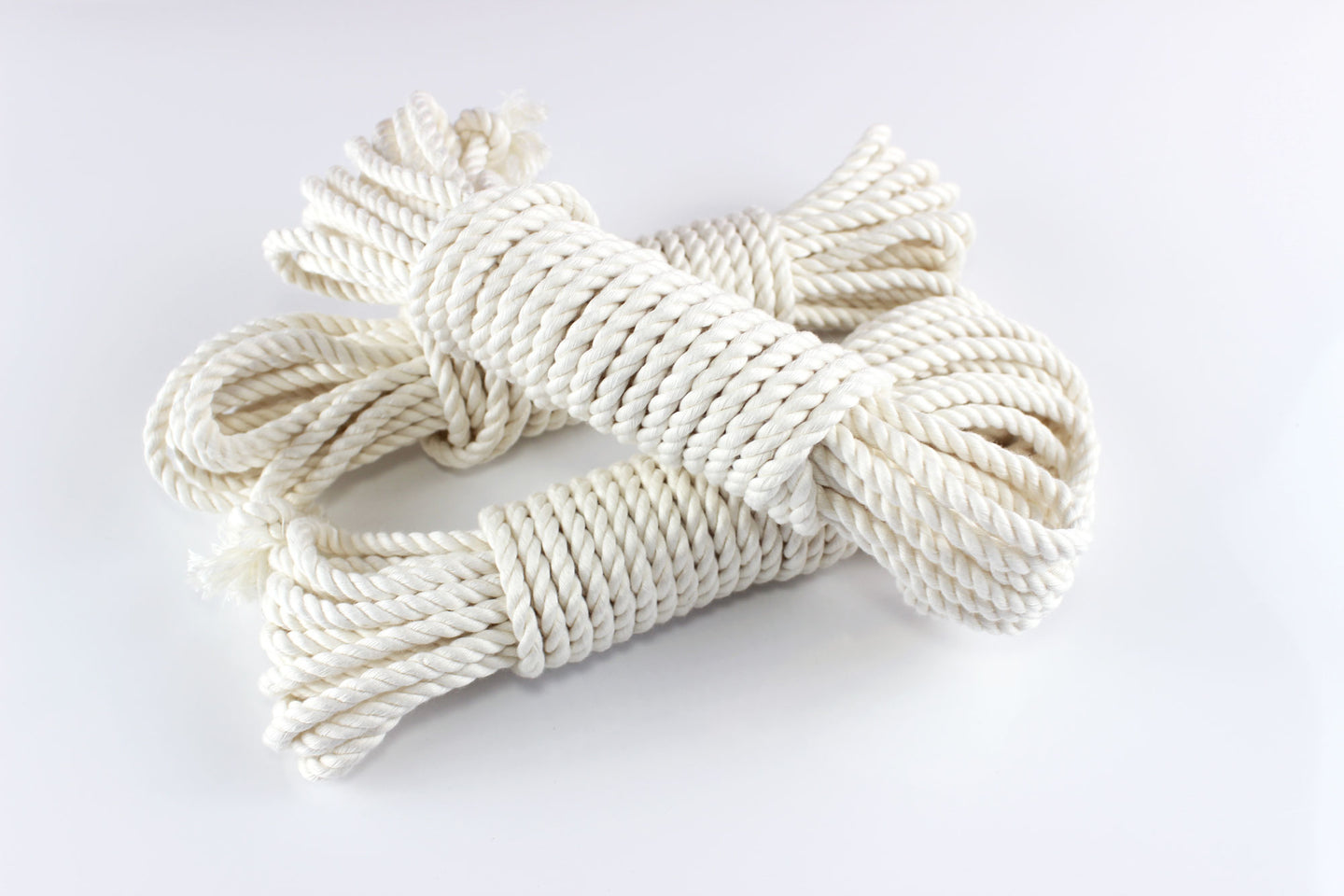 3 bundles of white bamboo silk rope on a white background