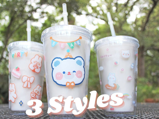 three Kawaii tumbler cup 16oz sitting on a table with three different cute patterns in an outdoor location.