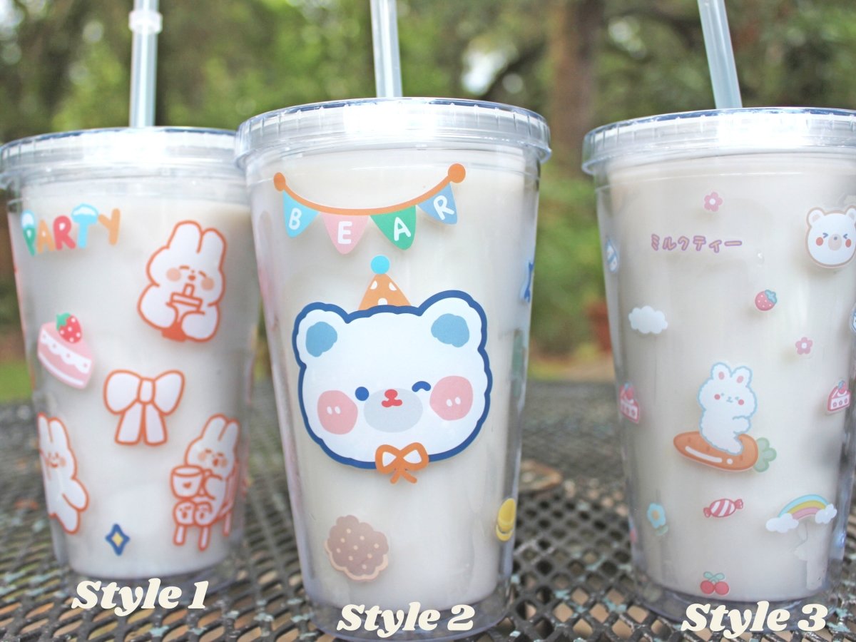 Three kawaii 16oz tumbler cups lined up to show off the varying patterns  on a table outside.